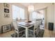 Bright dining room featuring a chandelier and sliding door access to the outdoor area at 7704 Himalayas Ave # 204, Las Vegas, NV 89128