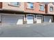 Row of garages featuring a clean driveway and stucco exterior at 7704 Himalayas Ave # 204, Las Vegas, NV 89128