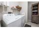 Laundry room featuring a white washer and dryer and shelving at 7704 Himalayas Ave # 204, Las Vegas, NV 89128