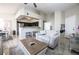 Bright open concept living and kitchen area with breakfast bar, tile floors, and contemporary design at 7704 Himalayas Ave # 204, Las Vegas, NV 89128