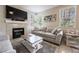 Cozy living room featuring a fireplace, TV, and comfortable seating, ideal for relaxation at 7704 Himalayas Ave # 204, Las Vegas, NV 89128