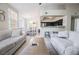 Spacious living area featuring tile floors, modern decor, and an adjacent kitchen with breakfast bar at 7704 Himalayas Ave # 204, Las Vegas, NV 89128