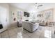 Bright living room features tile floors, a fireplace, and ample natural light from multiple windows at 7704 Himalayas Ave # 204, Las Vegas, NV 89128
