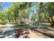 A picnic table sits on a concrete pad in a grassy park shaded by trees in a tranquil environment at 7704 Himalayas Ave # 204, Las Vegas, NV 89128