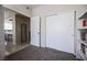 A room with closet and bookshelf features neutral carpet and access to other rooms in the house at 7704 Himalayas Ave # 204, Las Vegas, NV 89128