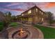 Spacious backyard with a built-in fire pit, covered patio, and lush artificial turf at 7761 Boyd Ave, Las Vegas, NV 89179