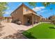 Backyard with artificial grass and a stone patio, perfect for outdoor entertaining at 7761 Boyd Ave, Las Vegas, NV 89179