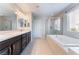 Bright bathroom featuring double vanity, soaking tub and glass enclosed shower at 7761 Boyd Ave, Las Vegas, NV 89179