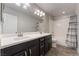 Bathroom features a double vanity, modern fixtures, and a shower over tub at 7761 Boyd Ave, Las Vegas, NV 89179