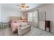 Charming bedroom with neutral paint, area rug, and light pink bed at 7761 Boyd Ave, Las Vegas, NV 89179