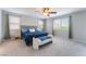 Serene bedroom with a blue comforter, bench, and ample natural light at 7761 Boyd Ave, Las Vegas, NV 89179