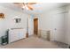 Bedroom featuring changing table, neutral carpet and a view of another room at 7761 Boyd Ave, Las Vegas, NV 89179