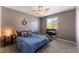 Cozy bedroom featuring plush carpet, a ceiling fan, and a TV at 7761 Boyd Ave, Las Vegas, NV 89179