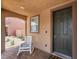 Inviting front entry with a cozy porch, stylish door, and desert-friendly landscaping at 7761 Boyd Ave, Las Vegas, NV 89179
