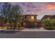 Charming two-story home with desert landscaping, brown exterior, and convenient three-car garage at 7761 Boyd Ave, Las Vegas, NV 89179
