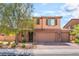 Charming two-story home with desert landscaping, brown exterior, and convenient three-car garage at 7761 Boyd Ave, Las Vegas, NV 89179