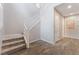Bright entryway showcases wood-look tile flooring and a staircase with white railing at 7761 Boyd Ave, Las Vegas, NV 89179