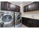Laundry room boasts built-in cabinets and modern appliances at 7761 Boyd Ave, Las Vegas, NV 89179