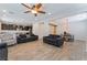 Open-concept living room featuring tile floors, recessed lights, and an adjacent kitchen at 7761 Boyd Ave, Las Vegas, NV 89179
