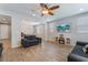 Open-concept living room featuring tile floors, recessed lights, and an adjacent dining area at 7761 Boyd Ave, Las Vegas, NV 89179