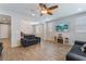 Open-concept living room featuring tile floors, recessed lights, and an adjacent dining area at 7761 Boyd Ave, Las Vegas, NV 89179