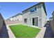 Charming backyard features a low-maintenance turf area bordered by rock and a gray privacy fence at 8043 Texas Hills St, Las Vegas, NV 89113