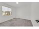 Bright and airy bedroom includes a window, neutral carpet and an overhead light at 8043 Texas Hills St, Las Vegas, NV 89113
