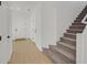 Bright foyer with wood-look flooring, a staircase, and access to the upper level at 8043 Texas Hills St, Las Vegas, NV 89113