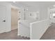 Bright hallway with neutral carpet, white walls, and staircase access at 8043 Texas Hills St, Las Vegas, NV 89113