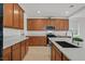 Modern kitchen featuring a large island, stainless steel appliances, and stylish wooden cabinetry at 8043 Texas Hills St, Las Vegas, NV 89113