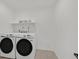 Laundry room featuring two front-load washer and dryer units at 8043 Texas Hills St, Las Vegas, NV 89113