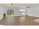 Bright living room with wood flooring, a ceiling fan, sliding glass doors and natural light at 8043 Texas Hills St, Las Vegas, NV 89113