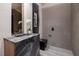 Stylish powder room with a unique stone sink, contemporary fixtures, and modern decor at 811 Magnum Cliff Ct, Henderson, NV 89012