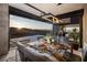 Elegant dining room with stunning views, modern light fixtures, and stylish furnishings at 811 Magnum Cliff Ct, Henderson, NV 89012