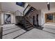 Grand foyer with floating staircase, modern art, and a temperature-controlled wine cellar at 811 Magnum Cliff Ct, Henderson, NV 89012