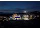 Night view of a contemporary home with a pool, offering luxurious outdoor living and scenic views at 811 Magnum Cliff Ct, Henderson, NV 89012