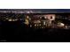 Stunning view of a modern home exterior with a sleek design and city lights in the background at 811 Magnum Cliff Ct, Henderson, NV 89012