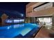 Modern home features an infinity pool, outdoor TV, and seamless indoor-outdoor living at 811 Magnum Cliff Ct, Henderson, NV 89012