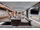 Open-concept living room with a fireplace, plush seating, and modern design elements at 811 Magnum Cliff Ct, Henderson, NV 89012