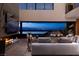Sophisticated living area with fireplace, expansive windows, and seamless flow to an outdoor entertainment space at 811 Magnum Cliff Ct, Henderson, NV 89012