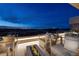 Inviting outdoor patio with comfortable seating offers stunning city views at night at 811 Magnum Cliff Ct, Henderson, NV 89012