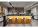 Stylish bar area with modern stools, sleek countertops, shelving, and contemporary decor at 811 Magnum Cliff Ct, Henderson, NV 89012