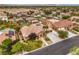 Aerial view of a beautiful home with a large driveway, three-car garage, and lush landscaping in a desert community at 8216 Tursi Lodge Ct, Las Vegas, NV 89131