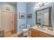 Bathroom featuring a single sink vanity, toilet, and shower with an orange curtain at 8216 Tursi Lodge Ct, Las Vegas, NV 89131