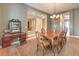 Dining room with a chandelier, neutral walls, shutters, carpet and with a glimpse into other living spaces at 8216 Tursi Lodge Ct, Las Vegas, NV 89131