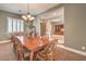 Elegant dining room featuring a chandelier, neutral paint, shutters, and an open floor plan at 8216 Tursi Lodge Ct, Las Vegas, NV 89131