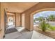 Inviting covered entryway showcasing stone pillars, desert landscaping, and a glimpse of the neighborhood at 8216 Tursi Lodge Ct, Las Vegas, NV 89131