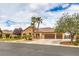 Attractive single-story home with a three-car garage, desert landscaping, and a neutral stucco exterior at 8216 Tursi Lodge Ct, Las Vegas, NV 89131