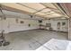 This large garage has lots of space, bright overhead lighting, shelving, and a workbench at 8216 Tursi Lodge Ct, Las Vegas, NV 89131