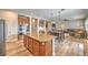 Open kitchen featuring stainless appliances, a center island and breakfast nook, with wood flooring at 8216 Tursi Lodge Ct, Las Vegas, NV 89131